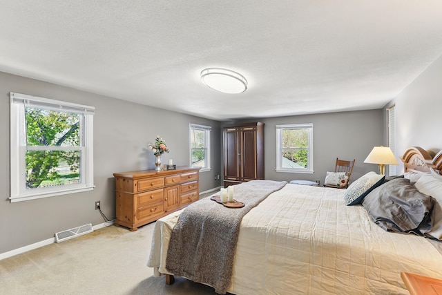 bedroom with light carpet and baseboards