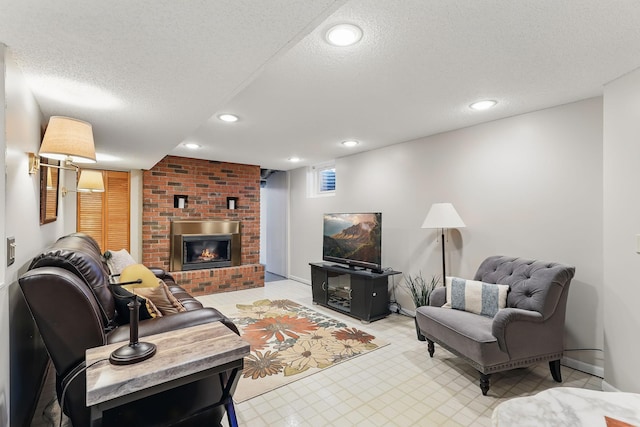living room with a textured ceiling, a brick fireplace, and recessed lighting