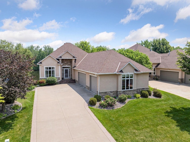11871 Flanders Cir NE, Blaine, MN 55449 - view of front of home featuring stucco siding, stone siding, a garage, concrete driveway, and a front lawn