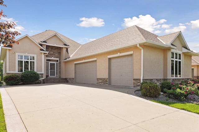 11871 Flanders Cir NE, Blaine, MN 55449 - view of front of house with stone siding, an attached garage, stucco siding, and concrete driveway