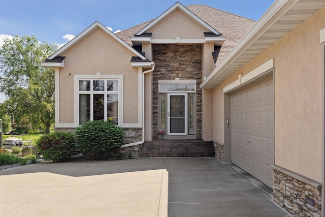 11871 Flanders Cir NE, Blaine, MN 55449 - view of front of home with stone siding, concrete driveway, stucco siding, an attached garage, and roof with shingles
