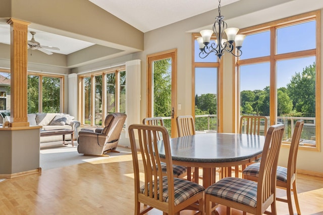 11871 Flanders Cir NE, Blaine, MN 55449 - dining area featuring healthy amount of natural light, light wood-type flooring, ornate columns, and a ceiling fan