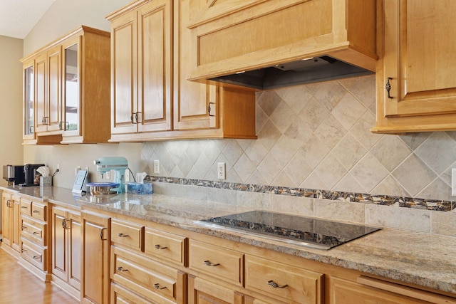 11871 Flanders Cir NE, Blaine, MN 55449 - kitchen featuring custom exhaust hood, black electric cooktop, light stone countertops, and backsplash