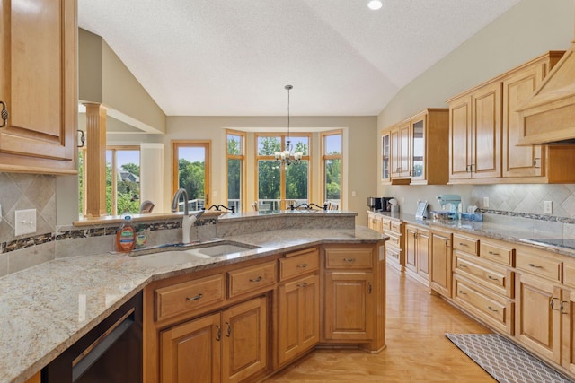 11871 Flanders Cir NE, Blaine, MN 55449 - kitchen featuring lofted ceiling, plenty of natural light, light stone countertops, black appliances, and custom exhaust hood
