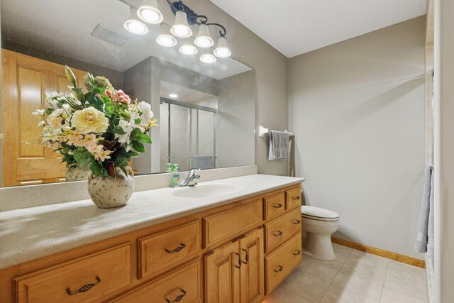 11871 Flanders Cir NE, Blaine, MN 55449 - bathroom featuring vanity, tile patterned flooring, and a stall shower