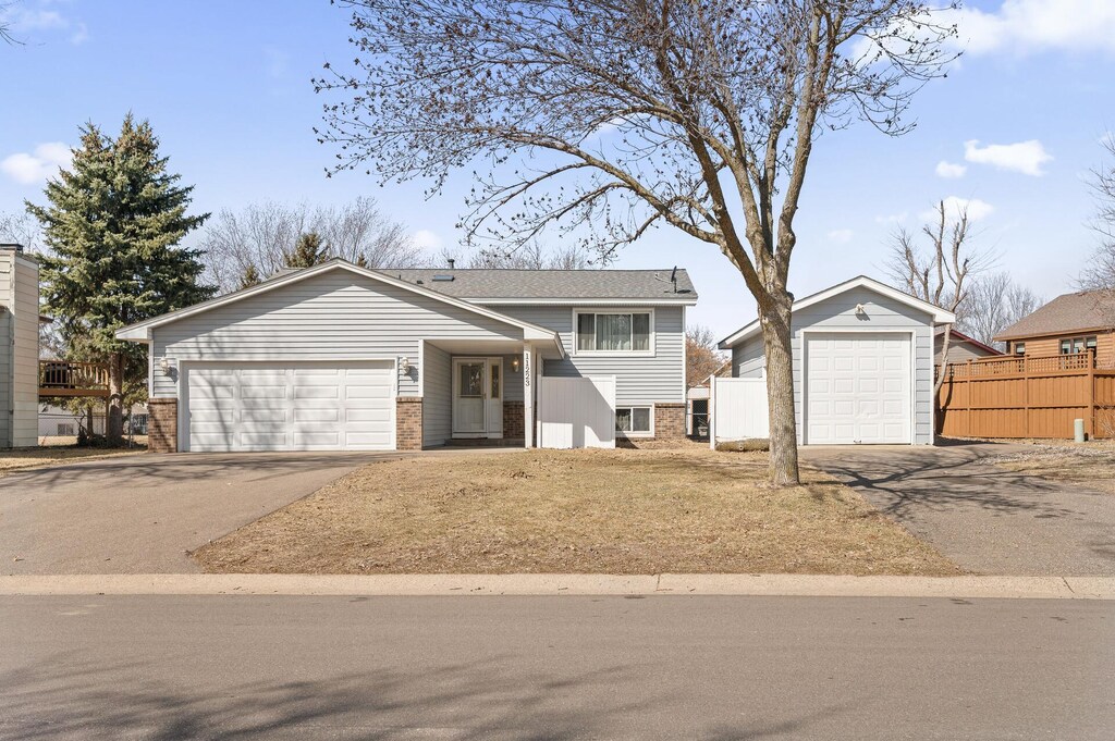 11223 Virginia Ave N, Champlin, MN 55316 - tri-level home with fence, brick siding, and aphalt driveway