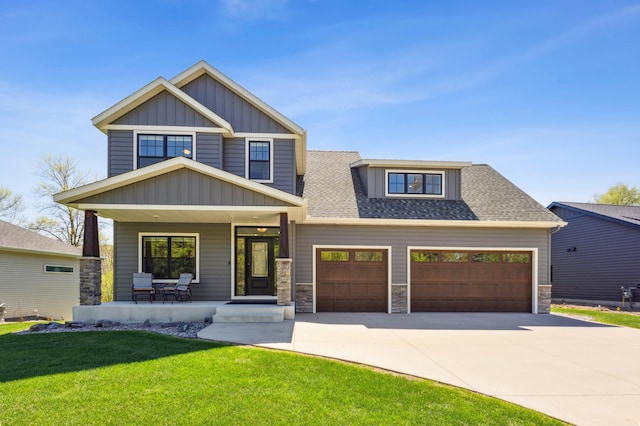 3344 26th Ave S, Saint Cloud, MN 56301 - craftsman-style home featuring a porch, board and batten siding, concrete driveway, a front lawn, and stone siding
