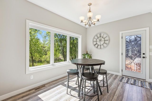 3344 26th Ave S, Saint Cloud, MN 56301 - dining room with a chandelier, baseboards, and wood finished floors