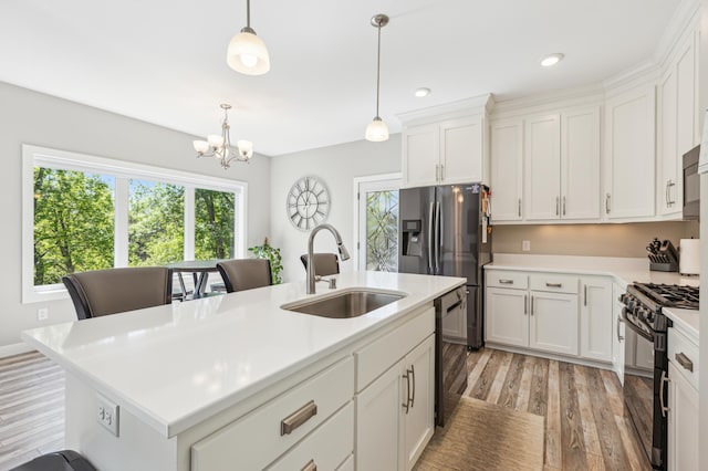 3344 26th Ave S, Saint Cloud, MN 56301 - kitchen with black appliances, a sink, light wood finished floors, plenty of natural light, and recessed lighting
