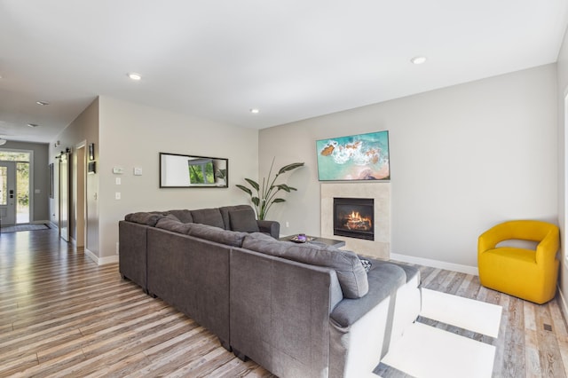 3344 26th Ave S, Saint Cloud, MN 56301 - living room with light wood finished floors, a tile fireplace, baseboards, and recessed lighting
