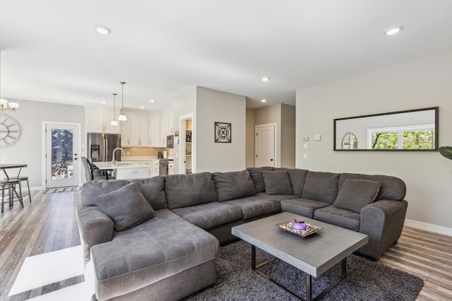 3344 26th Ave S, Saint Cloud, MN 56301 - living area featuring light wood-style flooring, recessed lighting, baseboards, and a chandelier