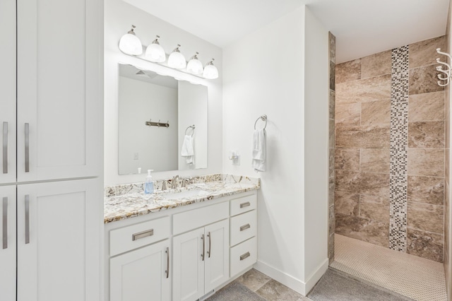 3344 26th Ave S, Saint Cloud, MN 56301 - bathroom featuring tiled shower, vanity, and baseboards