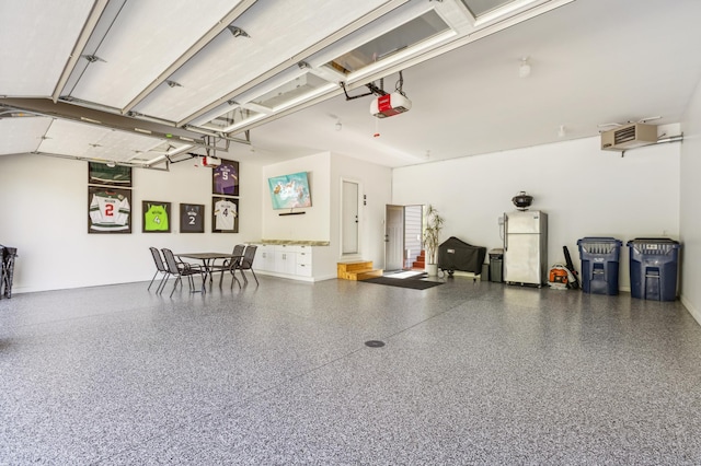 3344 26th Ave S, Saint Cloud, MN 56301 - garage with freestanding refrigerator and a garage door opener