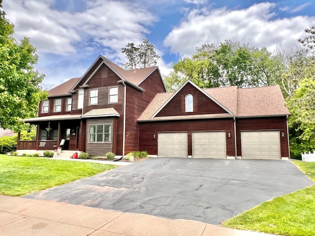 2543 Sunny Meadow Ln, Red Wing, MN 55066 - view of front of property featuring a porch, a garage, a front yard, and asphalt driveway