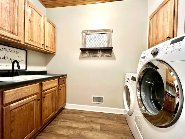2543 Sunny Meadow Ln, Red Wing, MN 55066 - laundry room featuring cabinet space, independent washer and dryer, dark wood-style floors, and baseboards