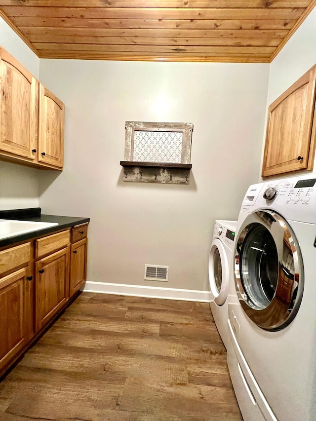 2543 Sunny Meadow Ln, Red Wing, MN 55066 - laundry area featuring wooden ceiling, washing machine and dryer, cabinet space, dark wood-style flooring, and baseboards