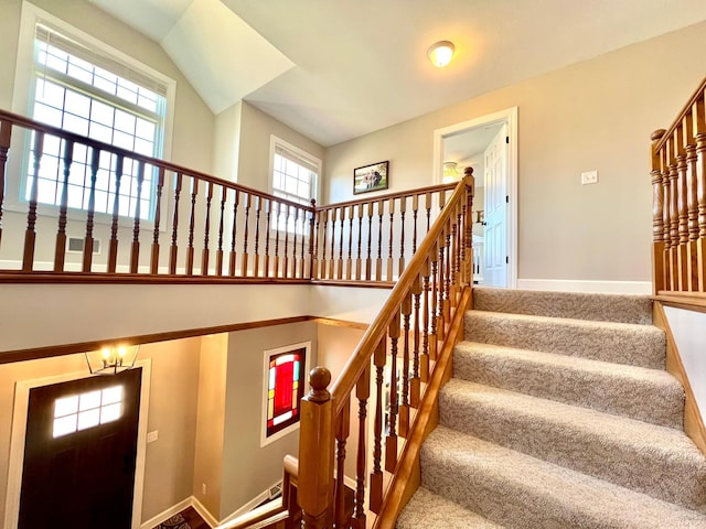 2543 Sunny Meadow Ln, Red Wing, MN 55066 - stairs with healthy amount of natural light, baseboards, and a towering ceiling