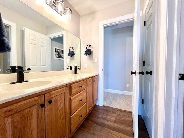 2543 Sunny Meadow Ln, Red Wing, MN 55066 - bathroom featuring double vanity, wood finished floors, and baseboards