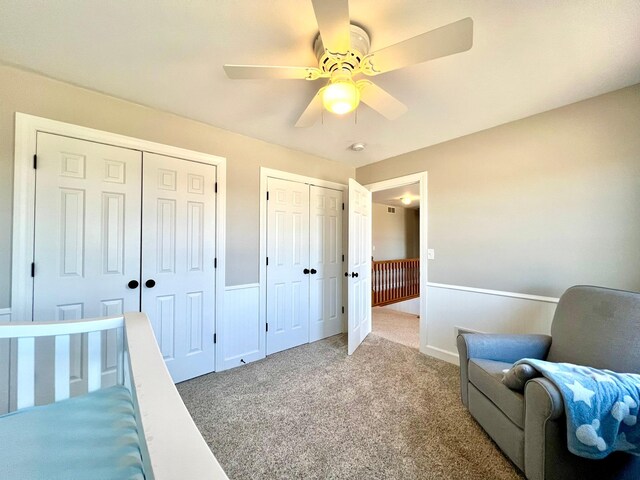 2543 Sunny Meadow Ln, Red Wing, MN 55066 - carpeted bedroom featuring multiple closets, wainscoting, and ceiling fan