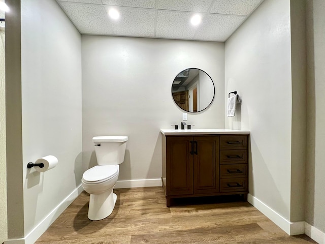 2543 Sunny Meadow Ln, Red Wing, MN 55066 - half bathroom with toilet, vanity, wood finished floors, baseboards, and a drop ceiling