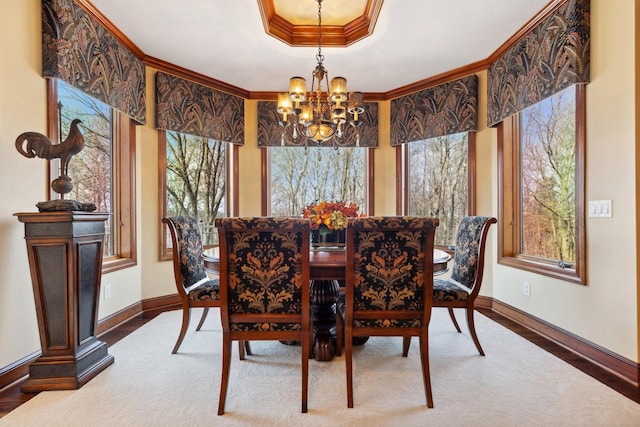 dining room with crown molding, baseboards, a chandelier, and a healthy amount of sunlight