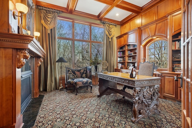 home office featuring beamed ceiling, a high ceiling, built in shelves, a fireplace with flush hearth, and coffered ceiling