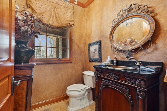half bath with vanity, baseboards, tile patterned floors, and toilet