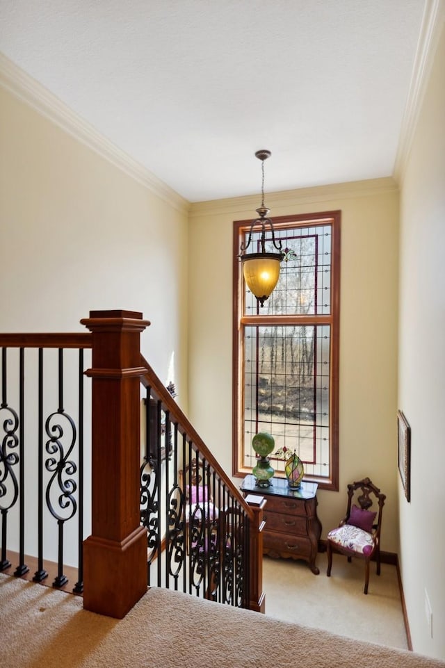 staircase featuring baseboards, ornamental molding, and carpet flooring