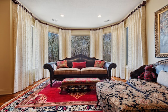 sitting room with recessed lighting, visible vents, and wood finished floors