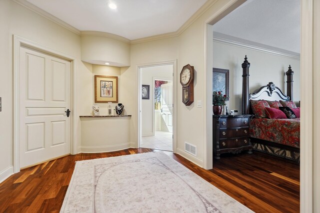 bedroom featuring crown molding, baseboards, dark wood-type flooring, and visible vents