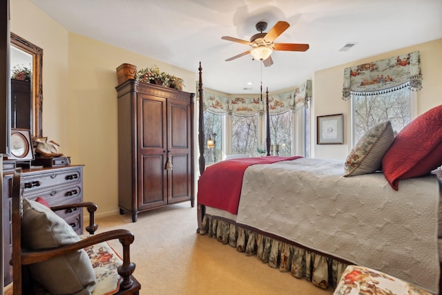 bedroom featuring a ceiling fan, baseboards, visible vents, and light carpet
