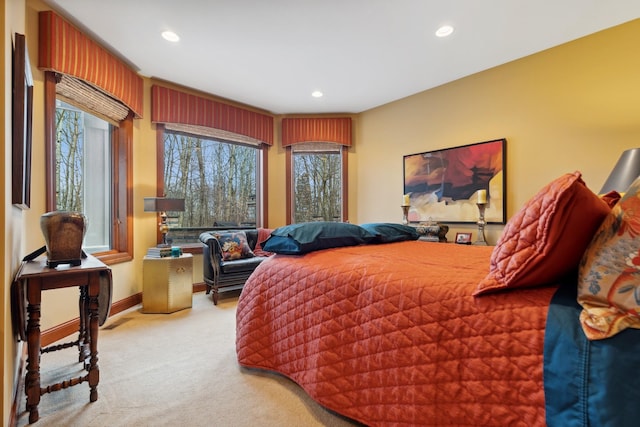 carpeted bedroom featuring baseboards and recessed lighting