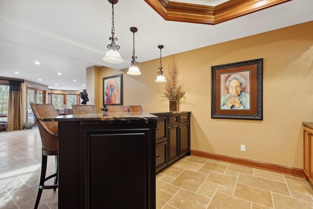 17620 Xanadu Ave, Jordan, MN 55352 - kitchen featuring a breakfast bar area, crown molding, a peninsula, decorative light fixtures, and dark cabinets