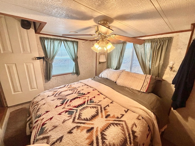 bedroom with a textured ceiling, ceiling fan, and crown molding