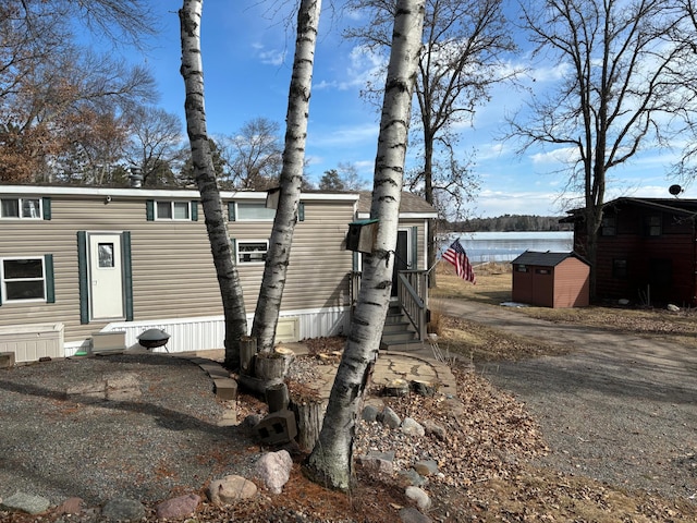view of front of home featuring an outdoor structure and a storage unit