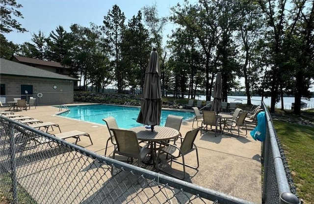 pool featuring fence and a patio area