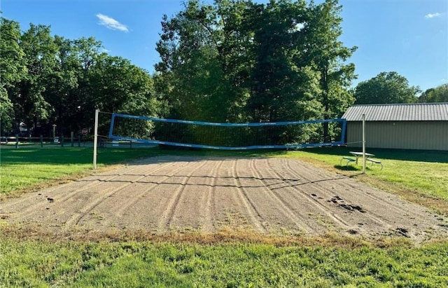 view of community featuring volleyball court and a lawn