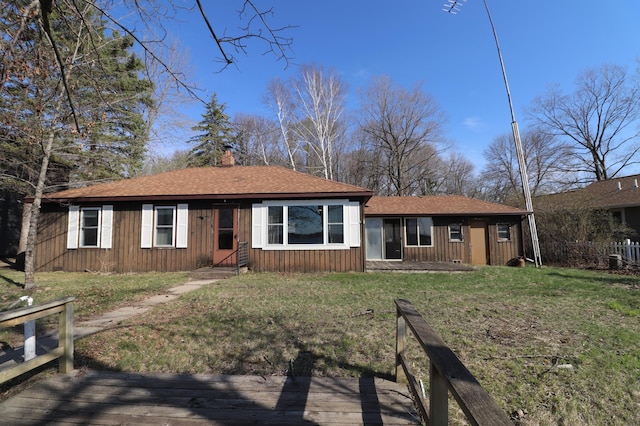 30304 Aspen Dr, Grey Eagle Twp, MN 56336 - view of front of house featuring roof with shingles, board and batten siding, a chimney, and a front lawn