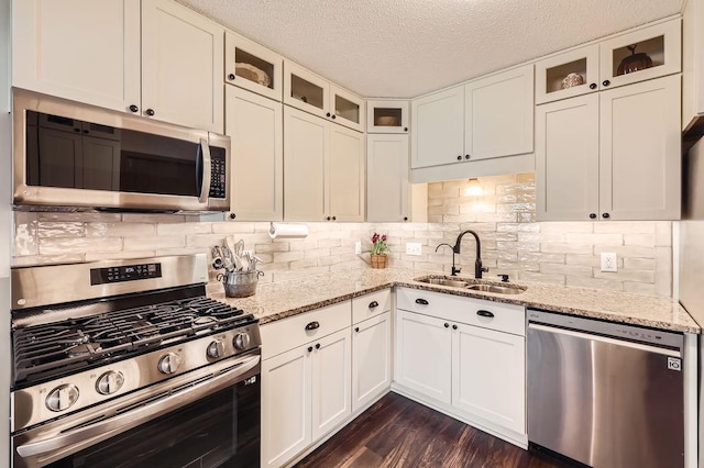 kitchen featuring a sink, white cabinetry, and appliances with stainless steel finishes