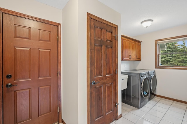 1159 Orwell Ave N, West Lakeland Twp, MN 55082 - laundry area featuring independent washer and dryer, cabinet space, baseboards, and light tile patterned floors