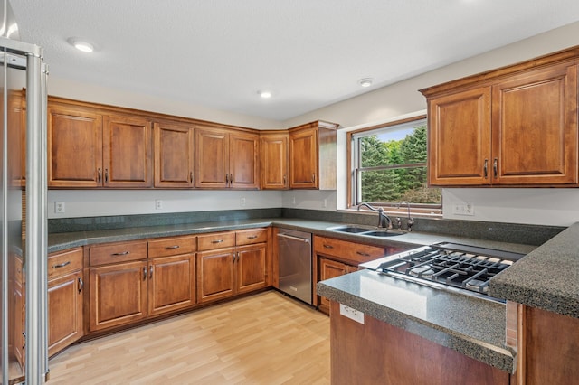 1159 Orwell Ave N, West Lakeland Twp, MN 55082 - kitchen with stainless steel appliances, a sink, brown cabinetry, dark countertops, and recessed lighting