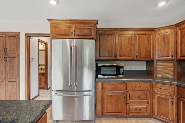 1159 Orwell Ave N, West Lakeland Twp, MN 55082 - kitchen with stainless steel appliances, brown cabinets, and a textured ceiling