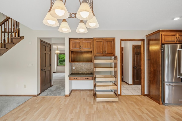 1159 Orwell Ave N, West Lakeland Twp, MN 55082 - kitchen with freestanding refrigerator, light wood-style flooring, baseboards, open shelves, and brown cabinetry