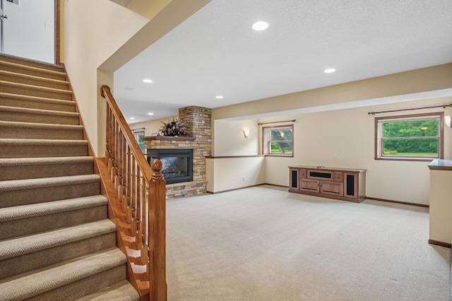 1159 Orwell Ave N, West Lakeland Twp, MN 55082 - stairway with carpet, recessed lighting, a stone fireplace, and baseboards