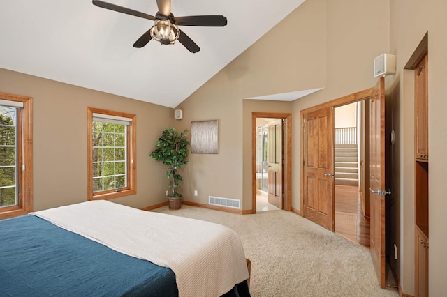 6507 Orchard Ridge Trl, Woodbury, MN 55129 - bedroom featuring light colored carpet, high vaulted ceiling, ceiling fan, and connected bathroom