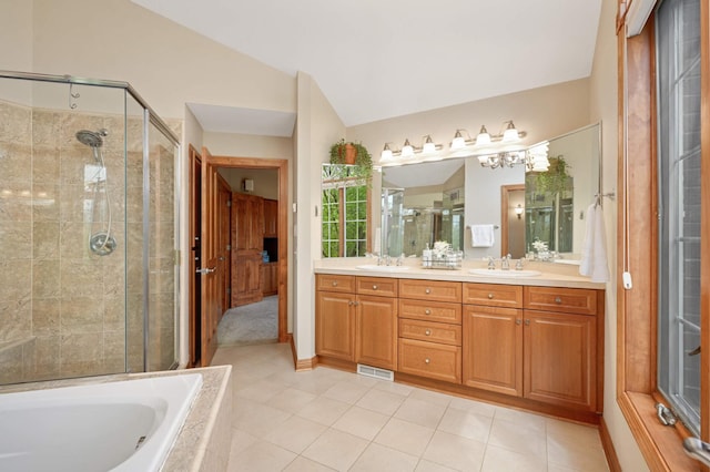 6507 Orchard Ridge Trl, Woodbury, MN 55129 - bathroom featuring double vanity, a stall shower, a garden tub, tile patterned flooring, and lofted ceiling
