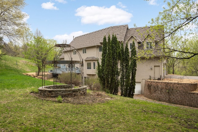 6507 Orchard Ridge Trl, Woodbury, MN 55129 - back of house featuring a yard, a shingled roof, and an attached garage