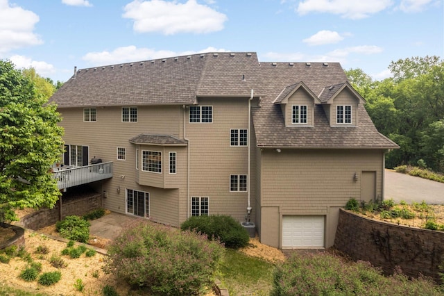 6507 Orchard Ridge Trl, Woodbury, MN 55129 - back of house with an attached garage, a shingled roof, and a wooden deck