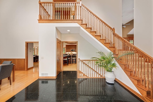 6507 Orchard Ridge Trl, Woodbury, MN 55129 - stairs with a high ceiling, granite tiled floors, and a wainscoted wall