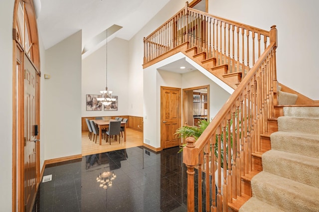 6507 Orchard Ridge Trl, Woodbury, MN 55129 - entrance foyer featuring granite floors, a high ceiling, a chandelier, and stairs